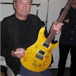 Ian Gillan with signed Fame guitar